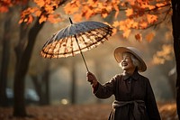 Old woman holding autumn plant. AI generated Image by rawpixel.