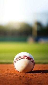 photo of Close-up of baseball on Grass Field with Blurry Stadium in Background. 