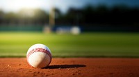 photo of Close-up of baseball on Grass Field with Blurry Stadium in Background. 