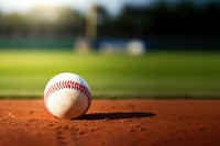 photo of Close-up of baseball on Grass Field with Blurry Stadium in Background. 