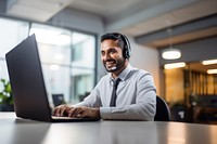 Photo of indian man working at call center, smilling talking to a laptop. AI generated Image by rawpixel.