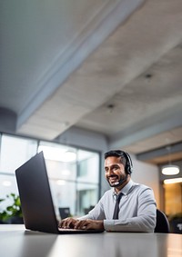 Photo of indian man working at call center, smilling talking to a laptop. AI generated Image by rawpixel.