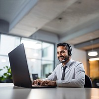 Photo of indian man working at call center, smilling talking to a laptop. AI generated Image by rawpixel.