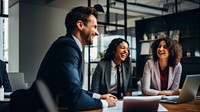 Photo of office workers laughing in the meeting room. 