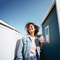 Portrait photo of a happy woman holding aluminum can looking at out side on minimal home. 