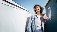 Portrait photo of a happy woman holding aluminum can looking at out side on minimal home. 