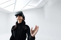 South-East asian girl playing VR game wearing all black outfit. 