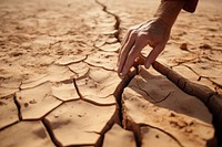 Racked earth desert floor hand outdoors nature. 