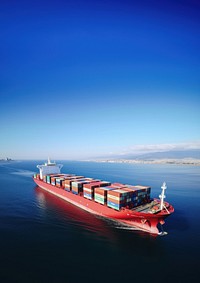 Aerial view of a large, heavily loaded container cargo ship. 