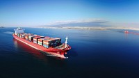 Aerial view of a large, heavily loaded container cargo ship. 