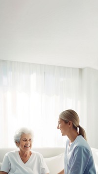 minimal, photo of staff caregiver talking to senior woman in hospital. 