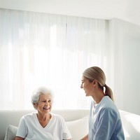 minimal, photo of staff caregiver talking to senior woman in hospital. 