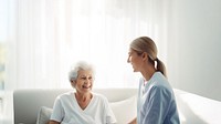 minimal, photo of staff caregiver talking to senior woman in hospital. 