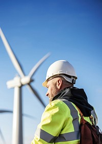 photo of wind turbine worker checking installation. AI generated Image by rawpixel.