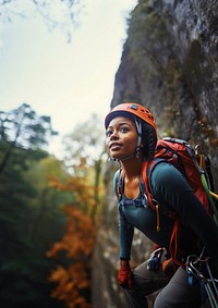 Photo of a african american female hiker go rock climbing. 