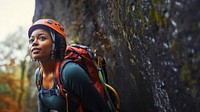 Photo of a african american female hiker go rock climbing. 