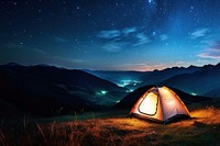 Photo of a tent, in a grass land, moutain in the background, at night, sky full of stars. 