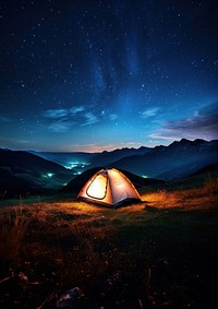 Photo of a tent, in a grass land, moutain in the background, at night, sky full of stars. 