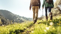 photo of hiking couple set off across hillside meadow. 