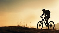 photo side view sillhuette of man riding a bicycle bike uphill with natural light. AI generated Image by rawpixel.