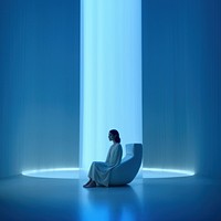 Woman sitting in a white room. 