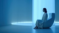 Woman sitting in a white room. 