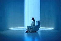 Woman sitting in a white room. 