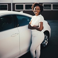 Woman standing by her car. 