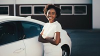 Woman standing by her car. 