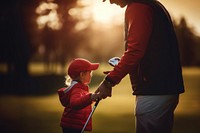 Dad playing golf with son. 