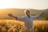 Joyful old man sunlight summer field. 