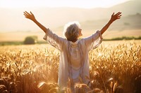 Joyful old woman sunlight summer field. 