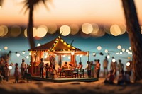 A small seaside party defocused outdoors night. 