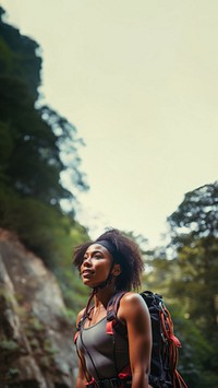 Photo of a african american female hikier go rock climbing. 