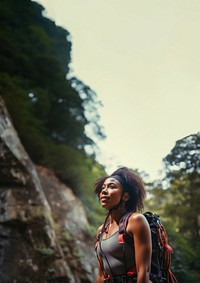 Photo of a african american female hikier go rock climbing. 