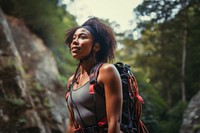 Photo of a african american female hikier go rock climbing. 