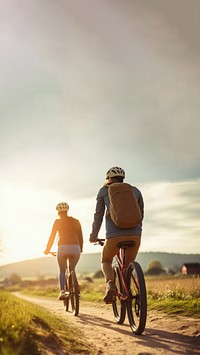 photo of couple riding bicycles through countryside. 