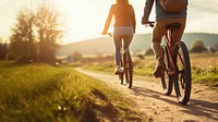 photo of couple riding bicycles through countryside. 