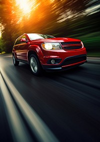 Dynamic shot of a red SUV speeding on a road. The red SUV is in motion, showcasing its sleek design. Sunlight highlights the red SUV's vibrant color.