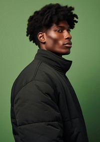 Black man wearing a black puffer jacket portrait adult photo. 