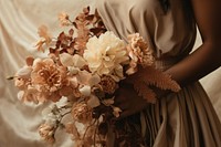 A woman hand holding flower bouquet fashion wedding dress. 