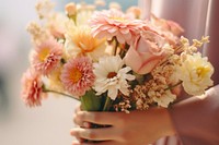 A woman hand holding flower bouquet blossom petal plant. 