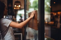 Barista hand turning open sign adult glass architecture. 