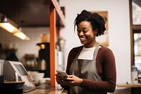 Smiling African entrepreneur standing holding adult. 