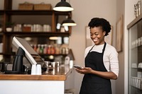 Smiling African entrepreneur standing holding cafe. 