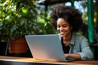 Joyful african woman laptop computer typing. 