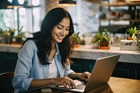 Joyful asian woman laptop furniture computer. 