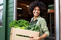 Grocery store vegetable carrying smiling. 