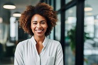 Happy african woman smiling portrait standing office. 