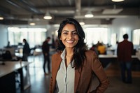 Happy indian woman smiling portrait standing office. 